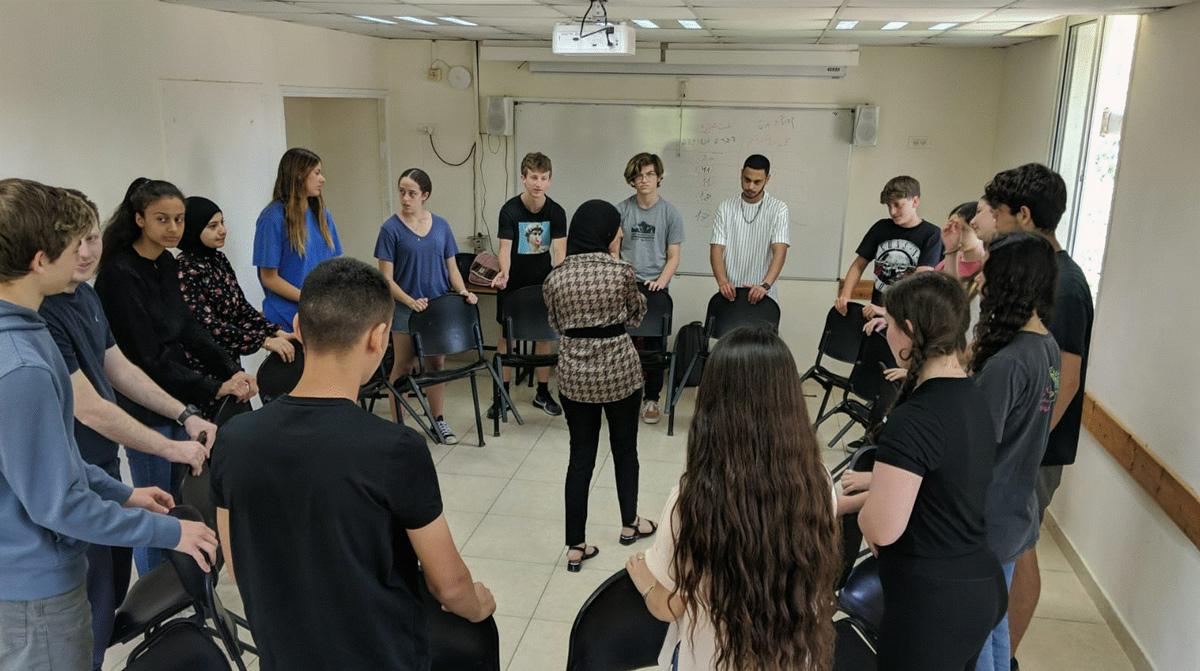 Youth sitting in a circle of chairs